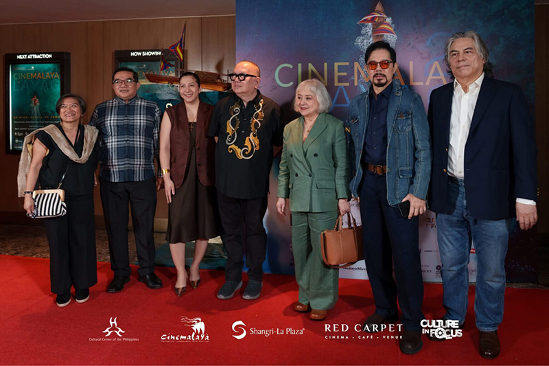 Festival organizers, executives, and filmmakers walk the red carpet at the opening of the 21st Cinemalaya Philippine Independent Film Festival